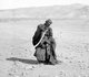 Arabia: A Bedouin man performing a sword dance, c. 1910